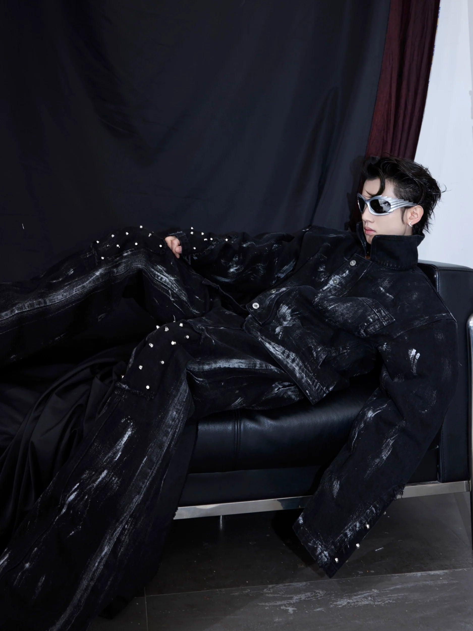 Distressed denim jacket with metal studs from vintage-inspired set, featuring raw edges and urban streetwear style