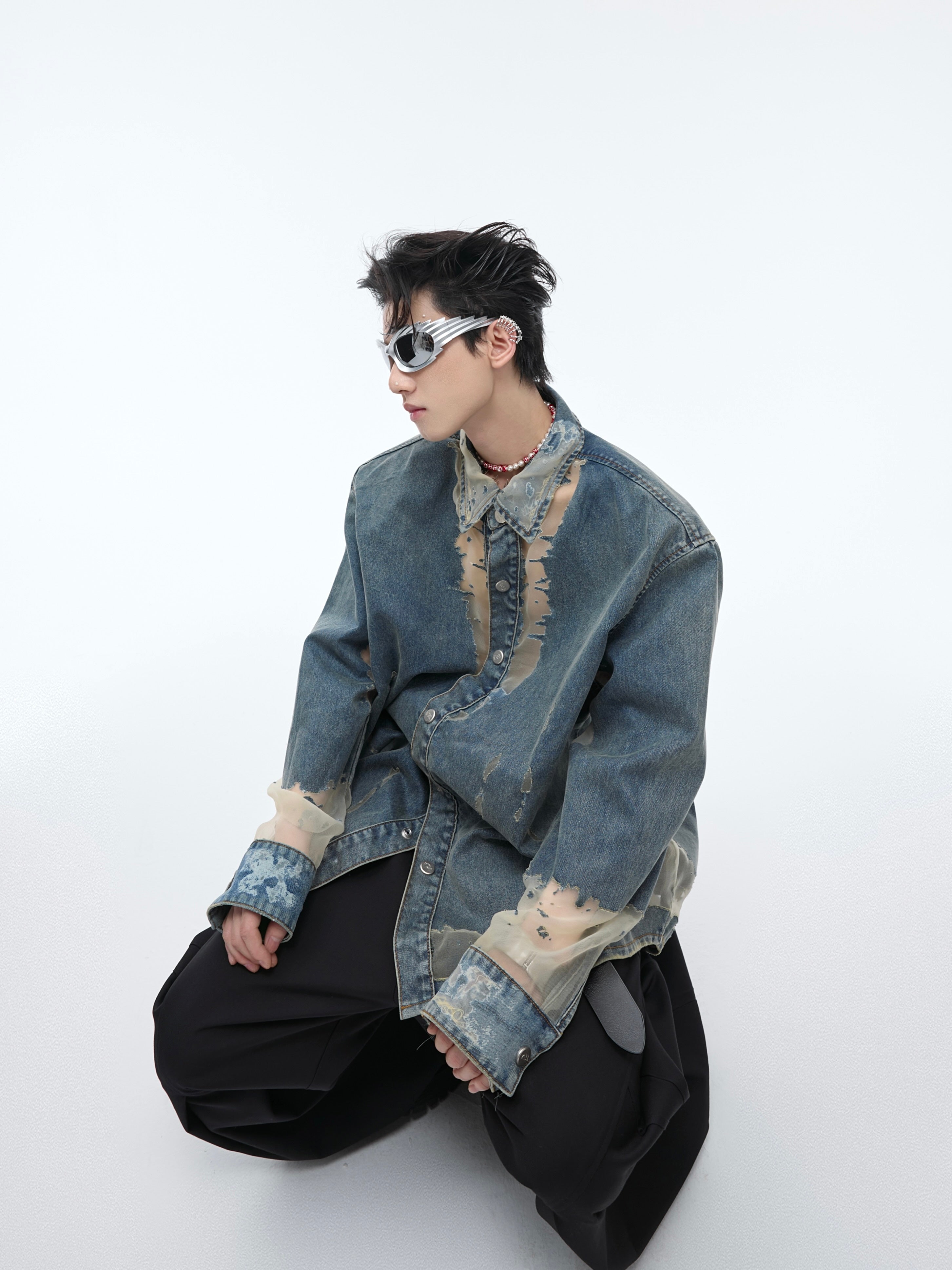 Front view of distressed denim shirt with delicate lace trim, showcasing urban streetwear style with deconstructed details