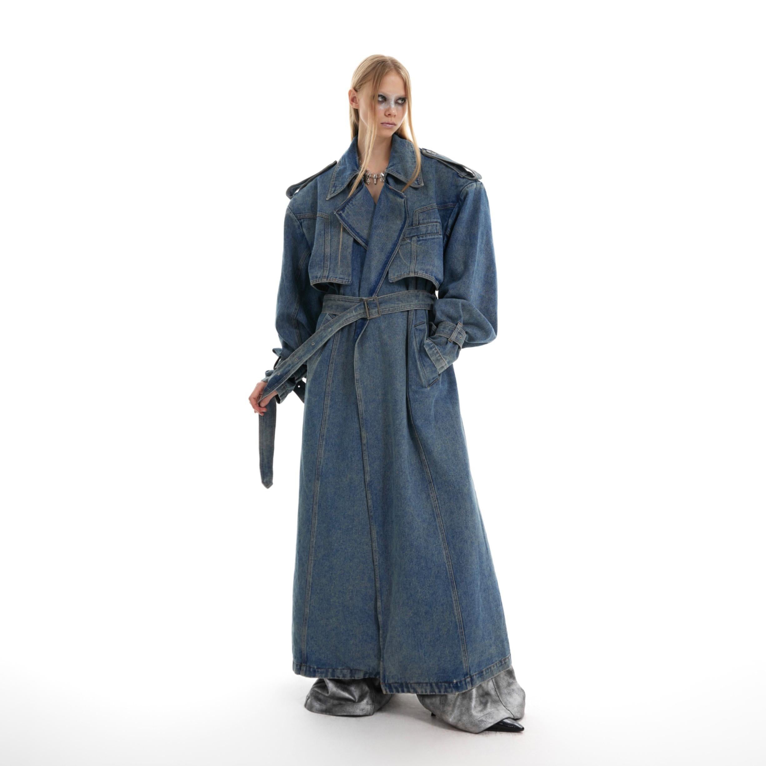 Distressed denim oversized trench coat with double-breasted front, showcasing unique streetwear style with vintage wash