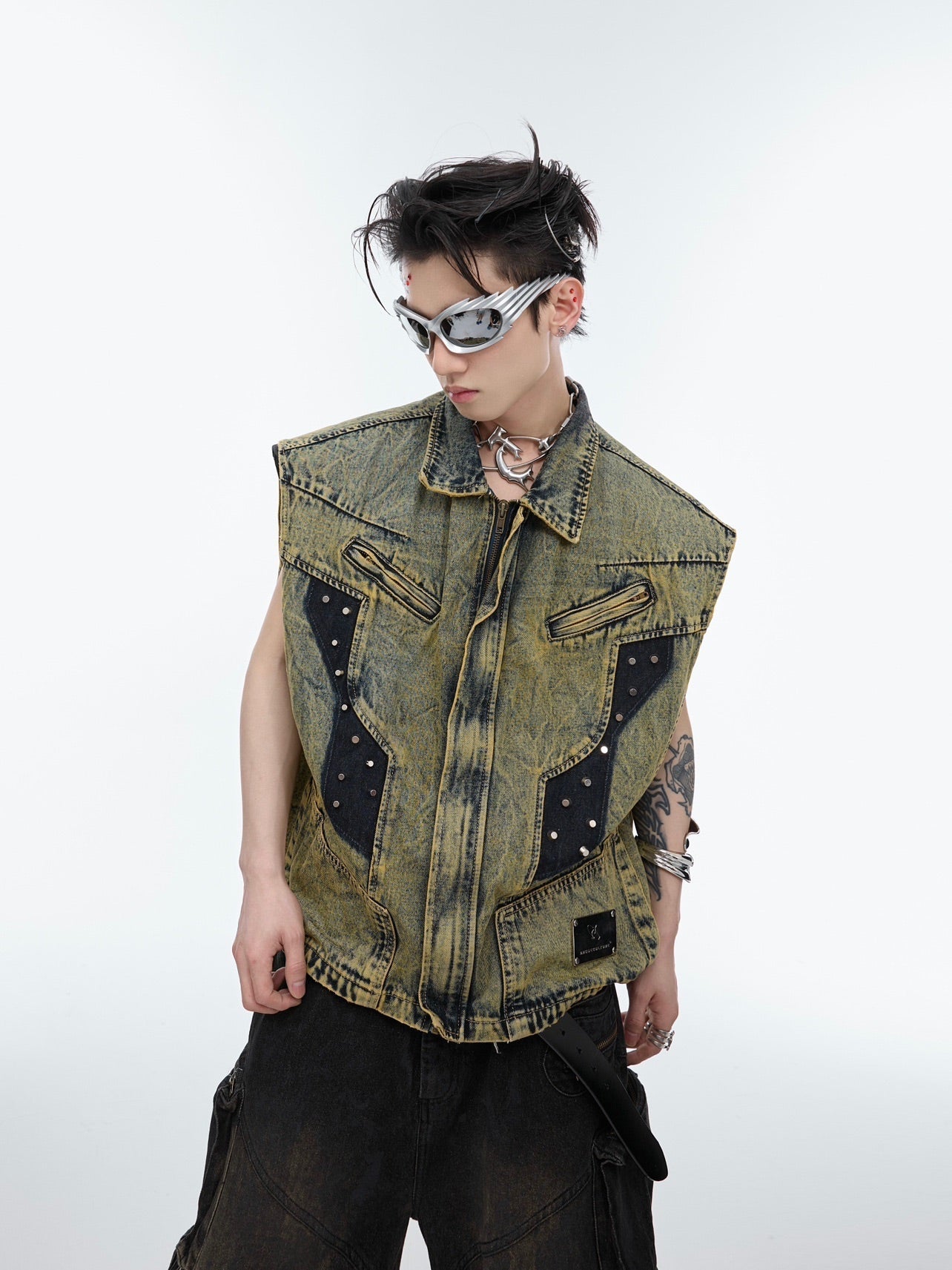 Close-up of raw edge detailing on deconstructed rivet denim jacket for edgy street style