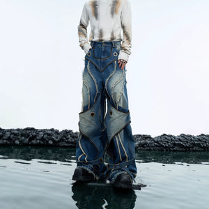 Distressed double-layer jeans with raw hem detail showing the loose retro fit and deconstructed style