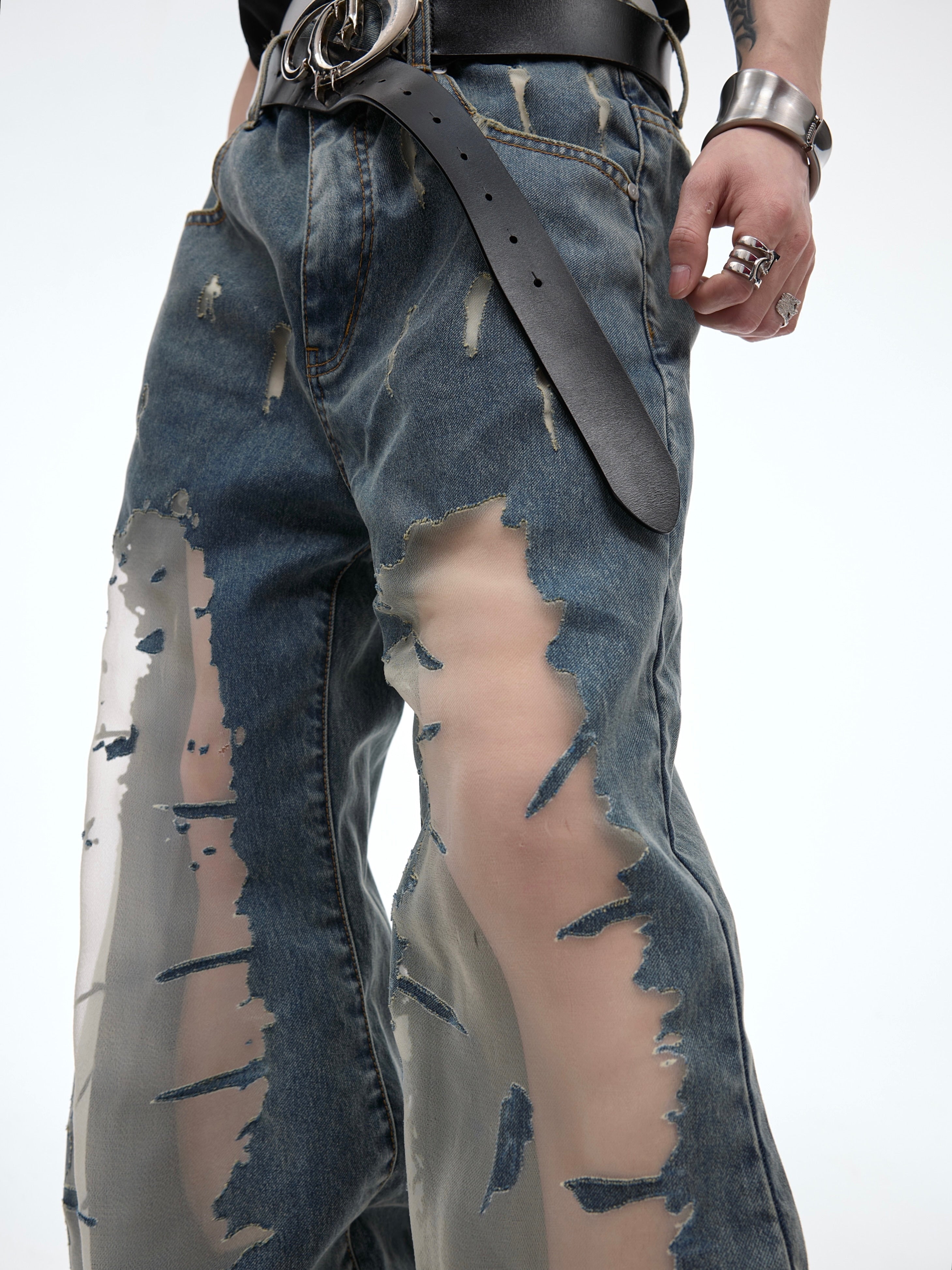 Side angle showing hollow-out details and distressed effects on these vintage flared jeans with urban street style