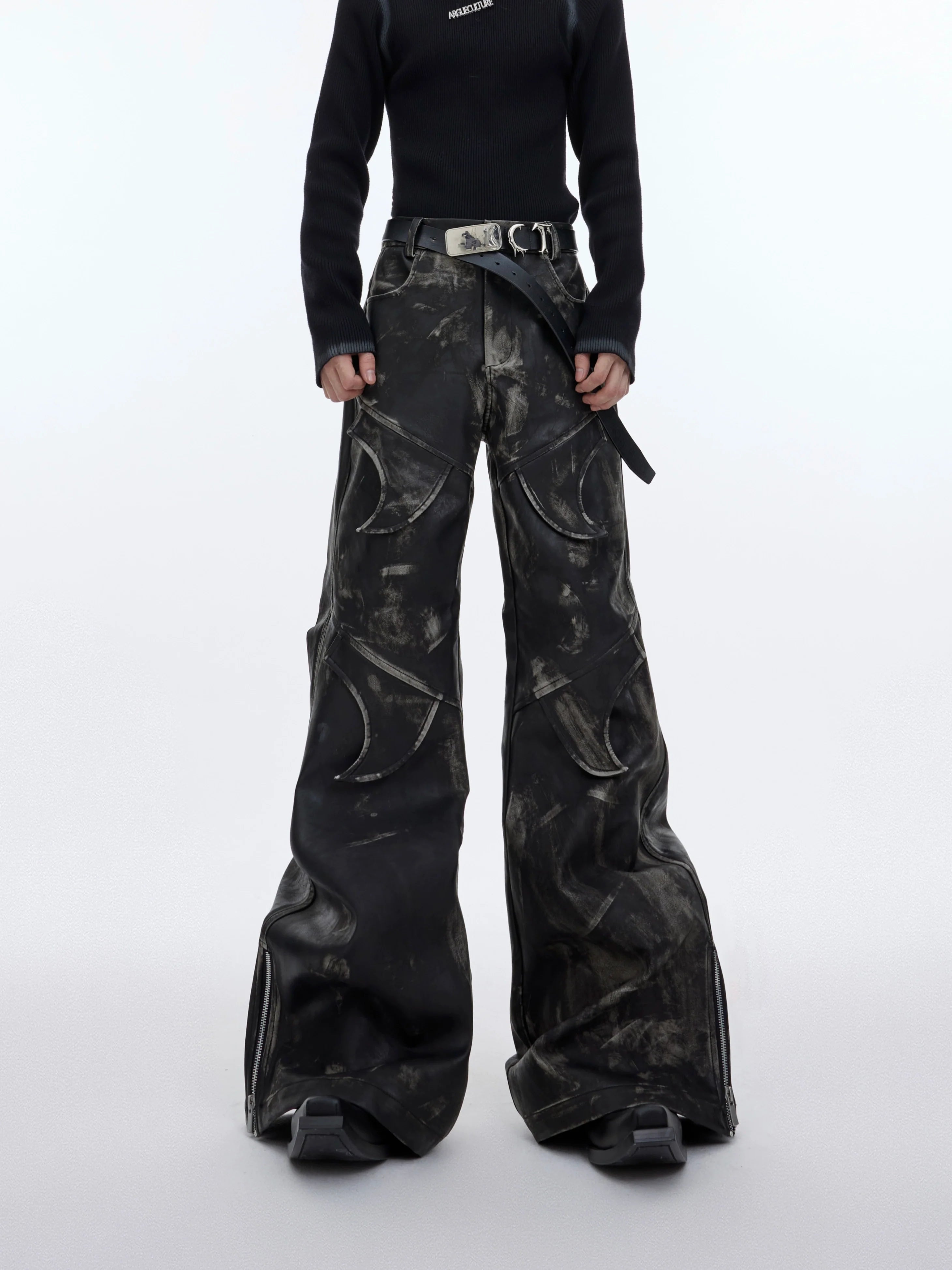 Vintage flared leather pants with distressed ink-wash technique and deconstructed paneling for edgy style