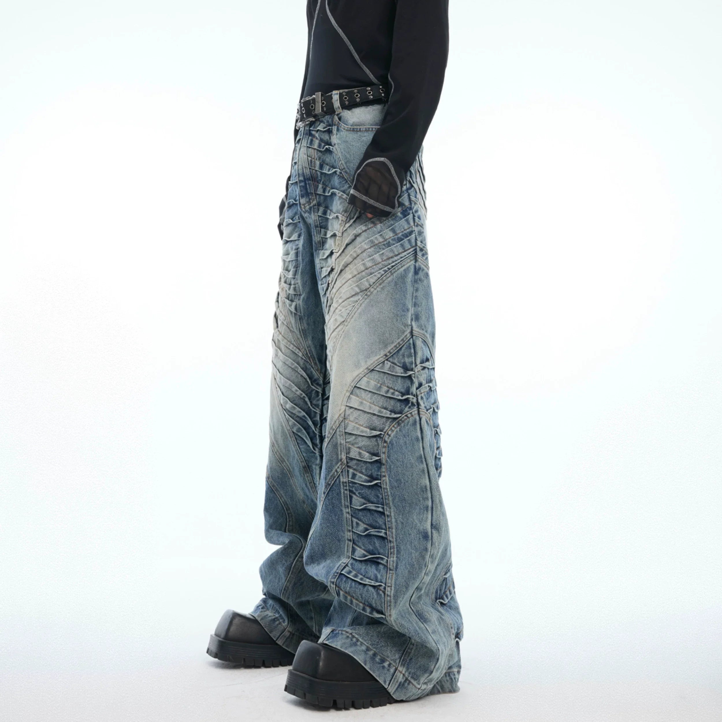 Distressed relaxed-fit jeans with vintage wash and wide leg silhouette, featuring double pleats for urban style