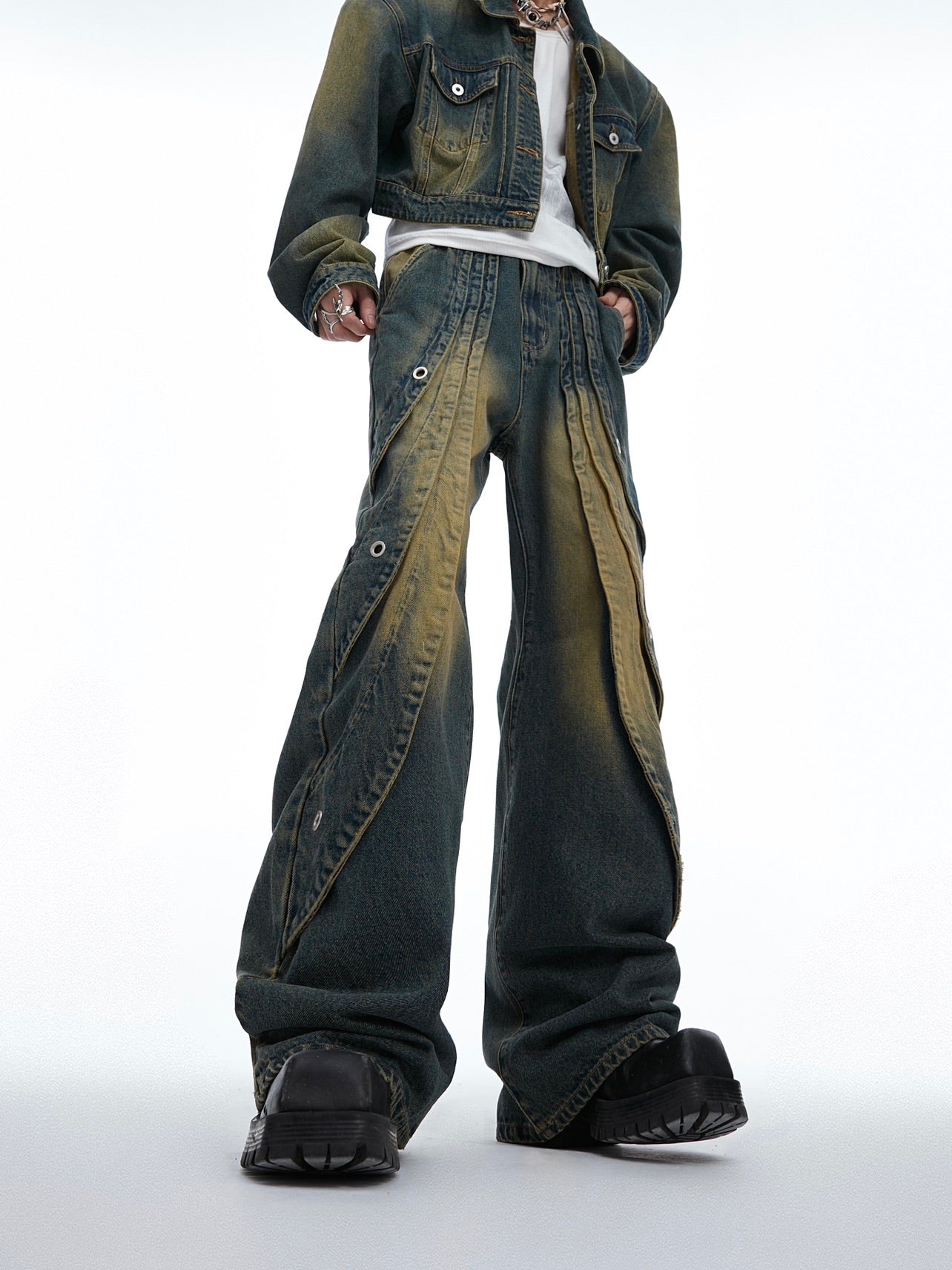 Distressed washed jeans featuring unique deconstructed ring details and ripped stitching for an edgy streetwear look