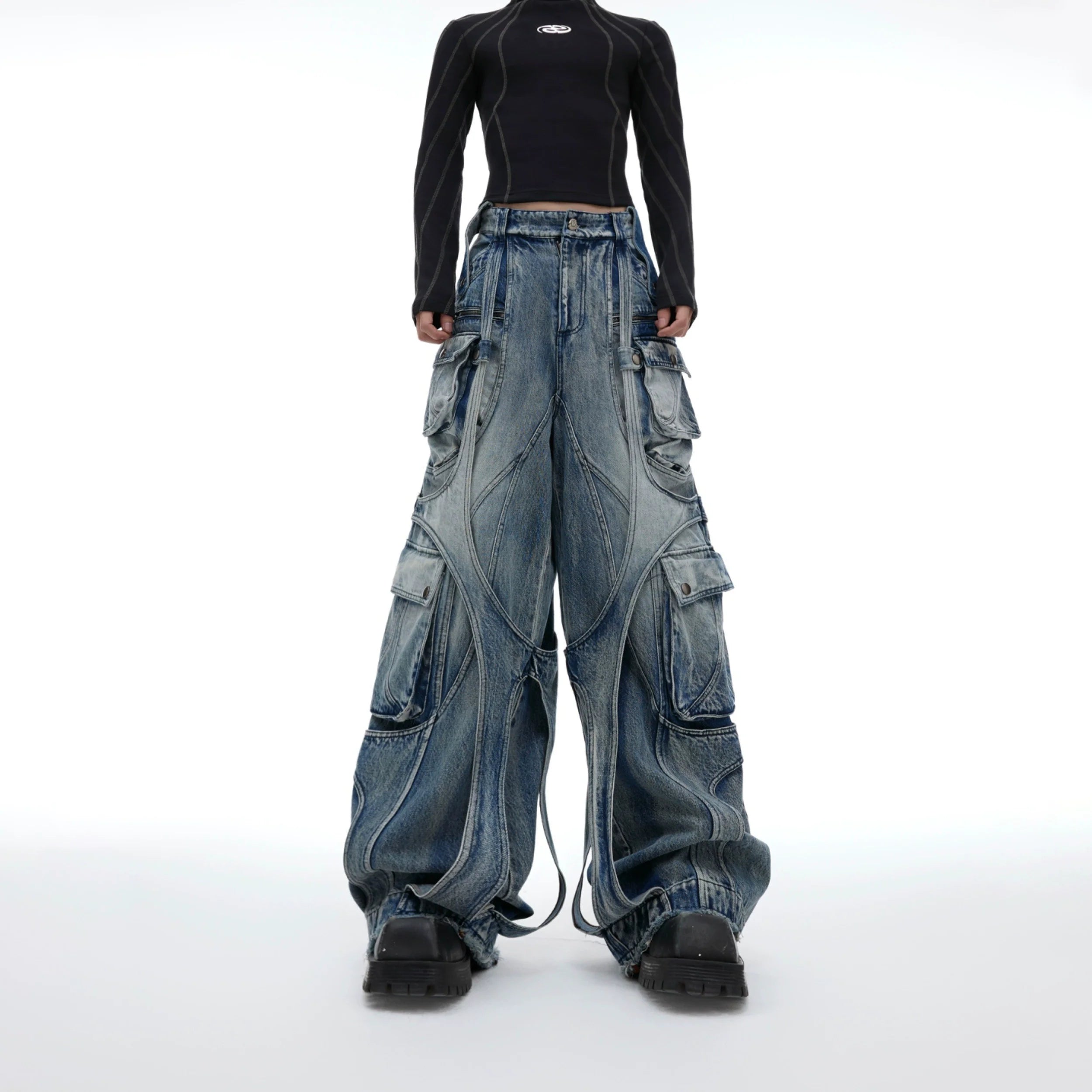 Front view of distressed wide-leg cargo jeans with raw hem detailing and drawstring waist, perfect for punk streetwear outfits