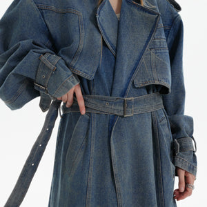 Back perspective of statement-making distressed denim trench coat with unique streetwear silhouette