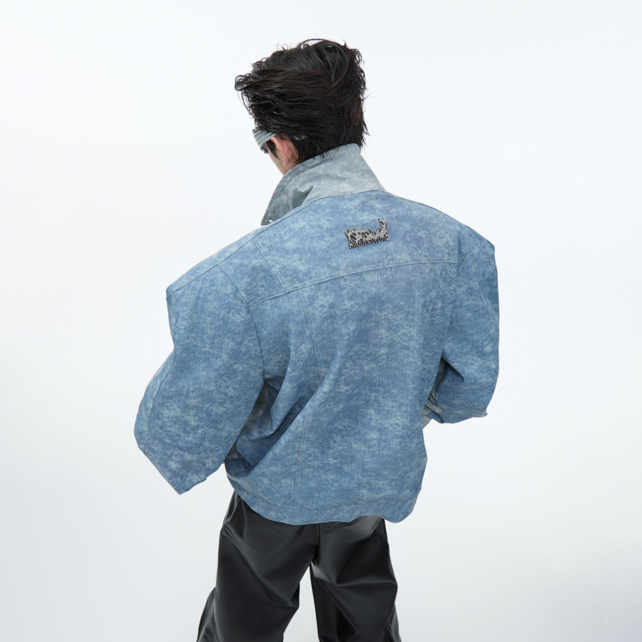 Close-up of unique double-sided denim and leather hybrid jacket with statement-making urban streetwear style