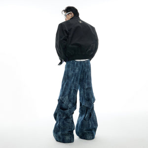 Back view of patchwork jeans featuring distressed details and decorative back pocket designs