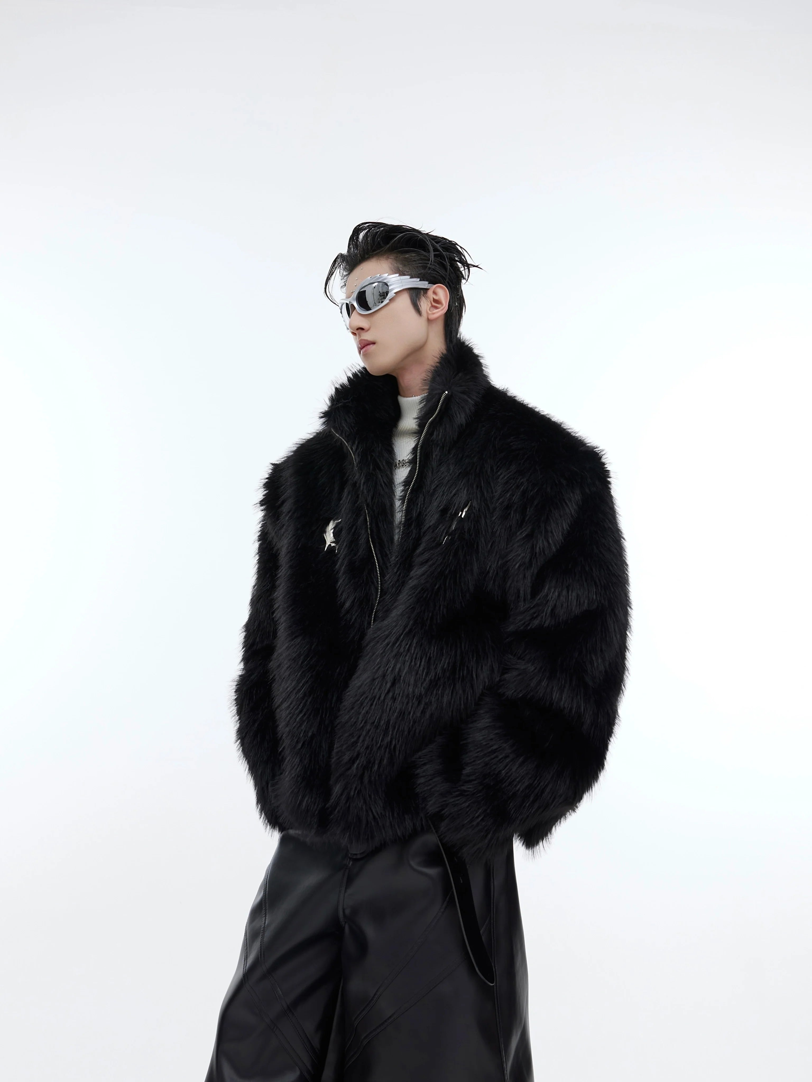 Cropped faux fur puffer jacket with metallic streetwear buckles, showcasing avant-garde deconstructed design