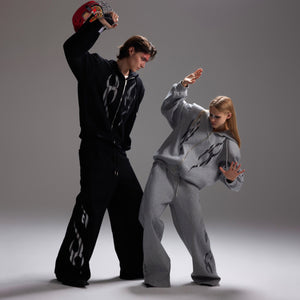 Flat lay of complete hoodie set displaying full flame print design and oversized dimensions