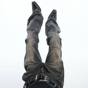Side angle of gray flared denim pants showcasing the slub fabric texture and urban streetwear style
