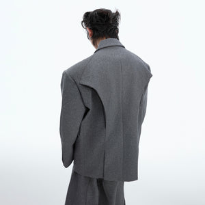 Detailed view of unique fold design on loose-fit deconstructed blazer for fashion-forward look