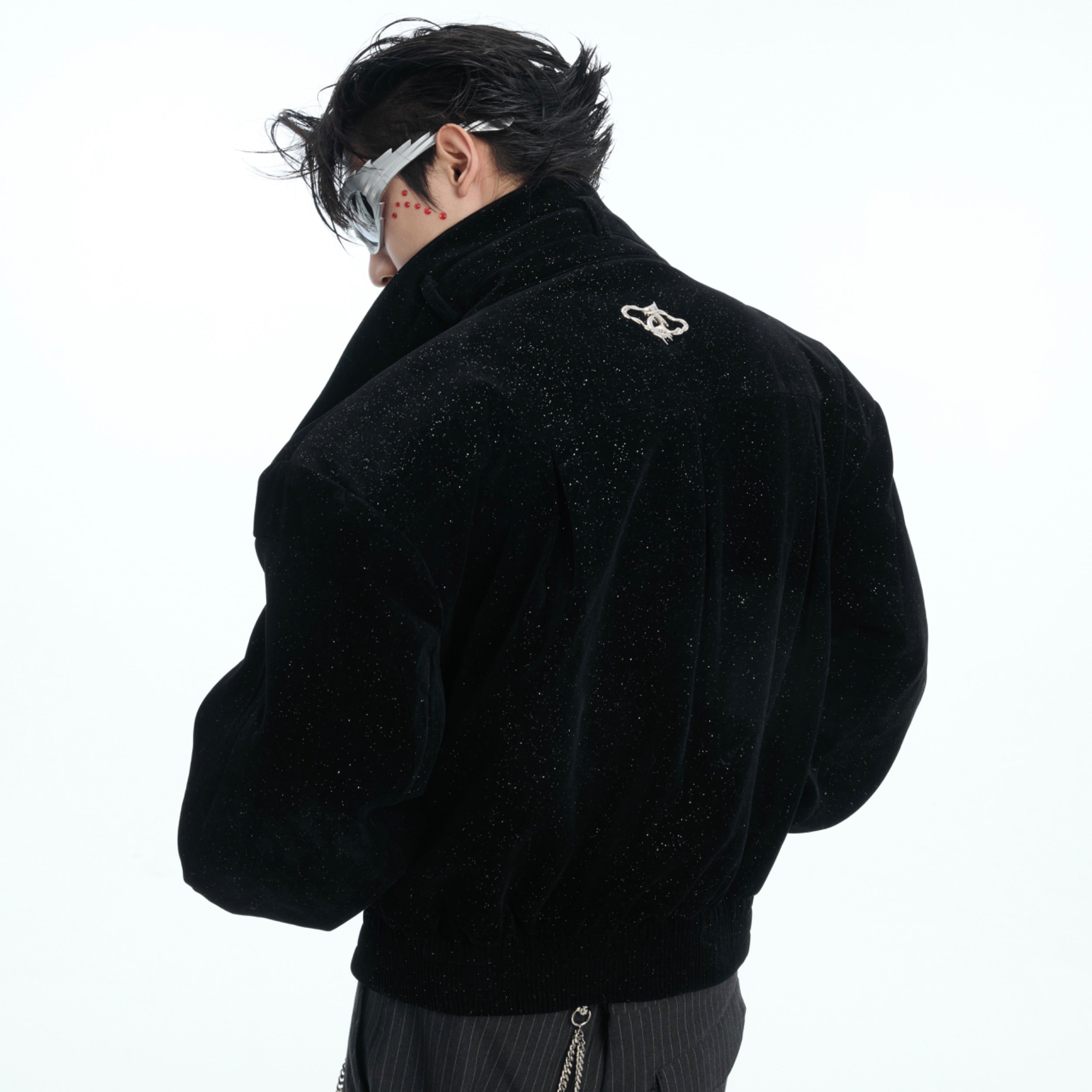 Close-up detail of the unique diagonal zipper with serpentine metal design on this fashion-forward cropped jacket