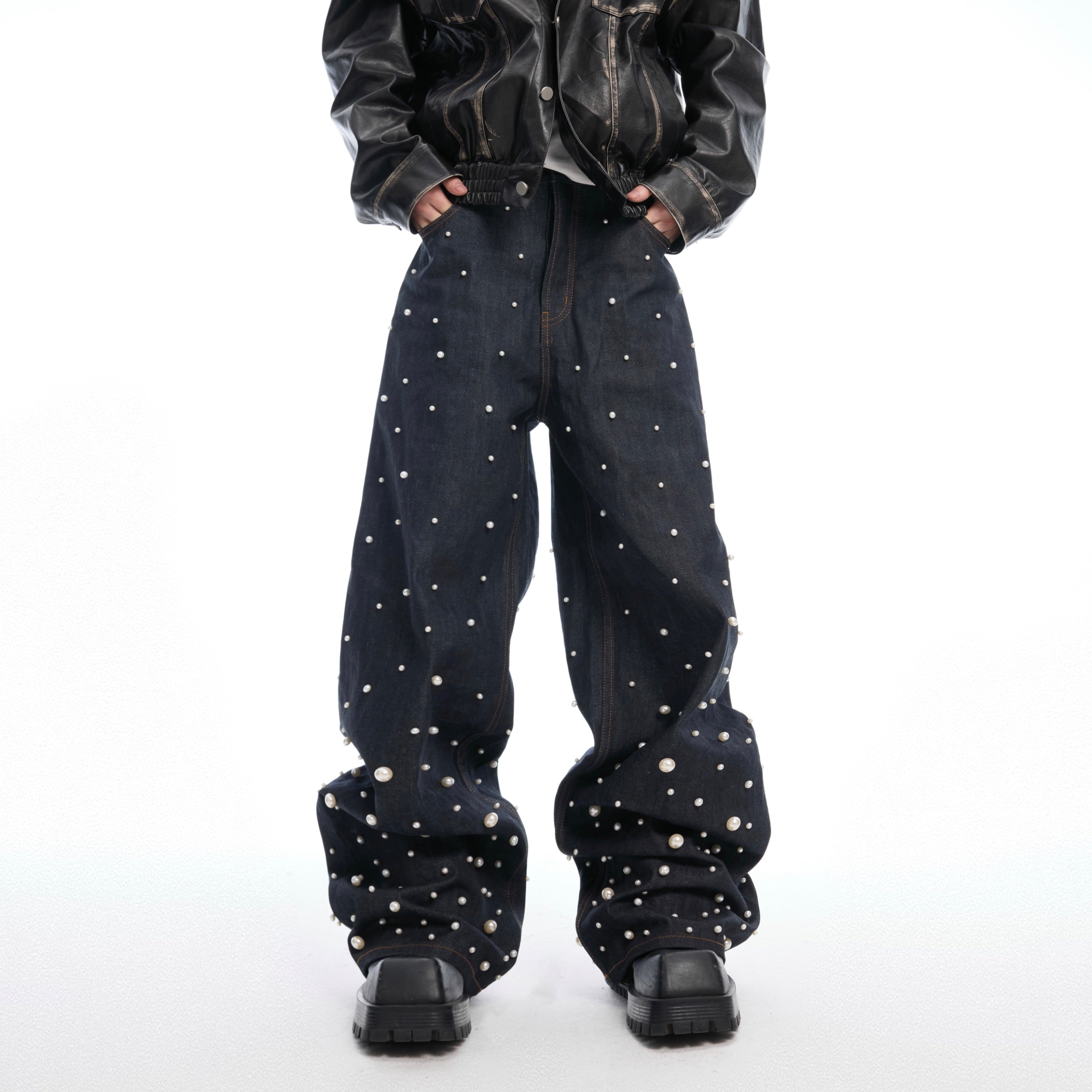 Front view of hand-stitched pearl raw denim jeans showing selvedge detail and unique pearl patchwork design