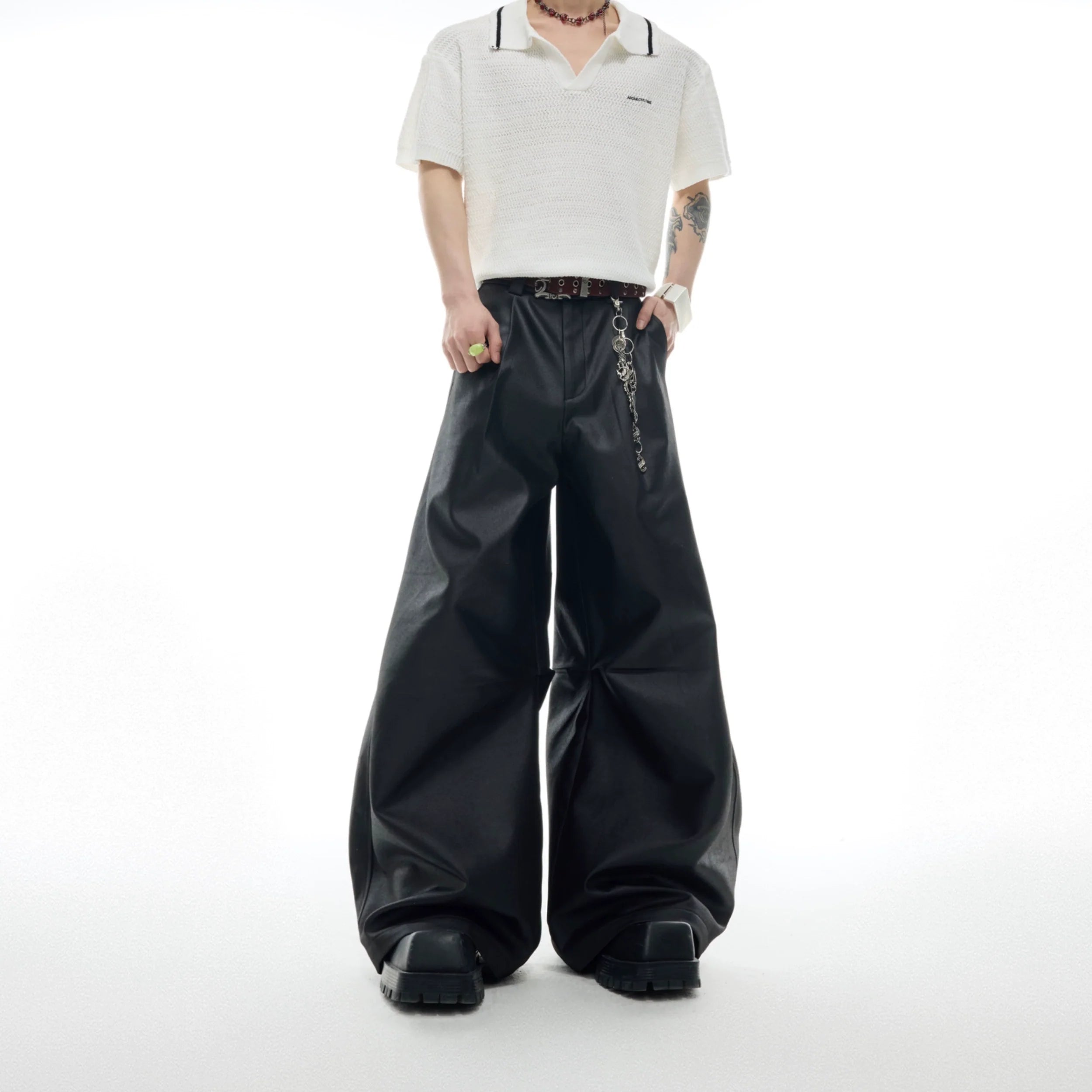 Front view of heavyweight coated cargo pants with wide leg silhouette and metallic accents for streetwear fashion