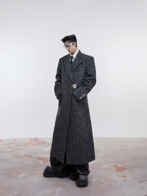 Front view of heavyweight trench coat showing its razor-sharp lines and powerful architectural silhouette
