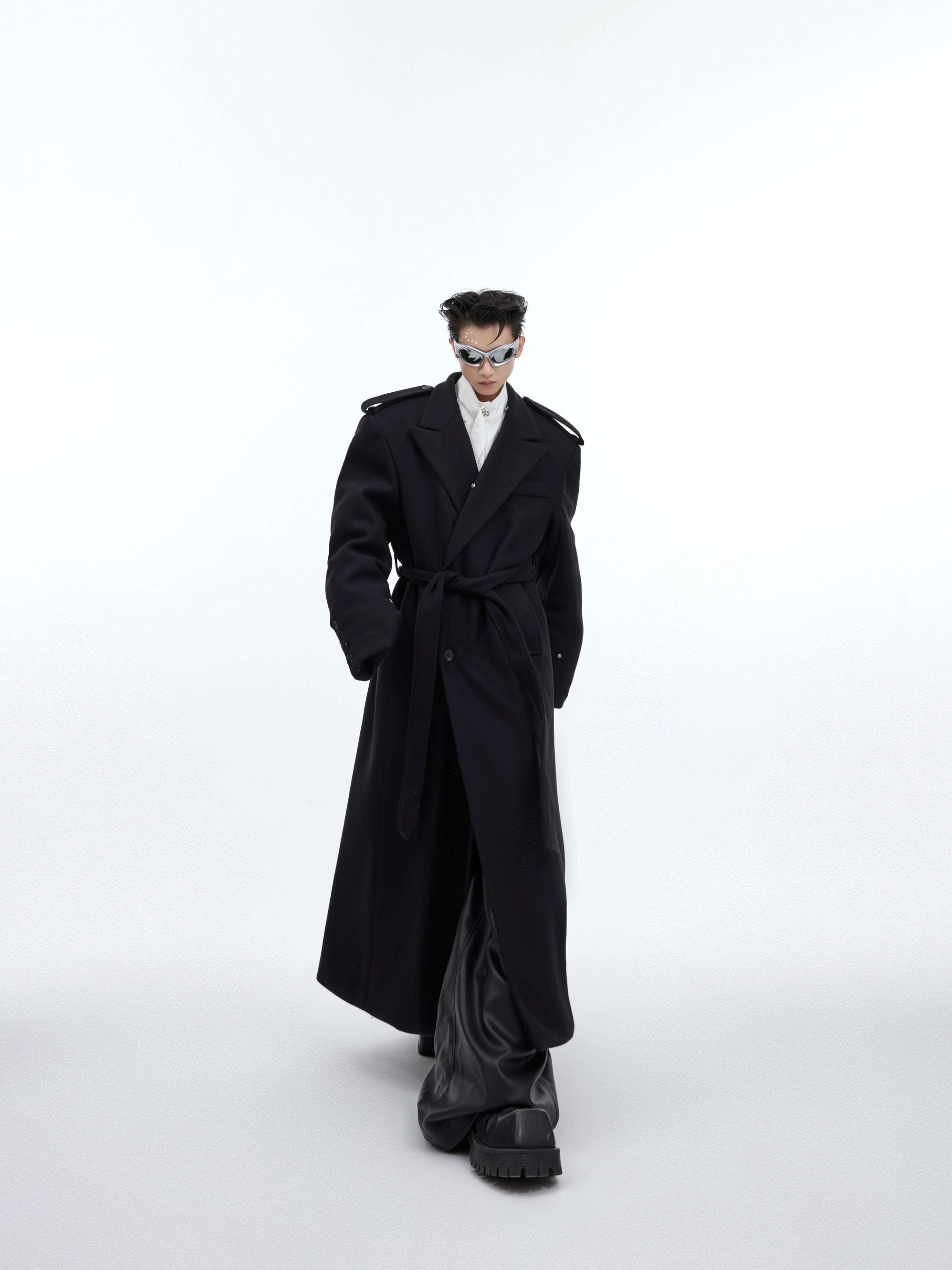 Side view of deconstructed British wool coat featuring oversized fit and premium polyester-wool blend