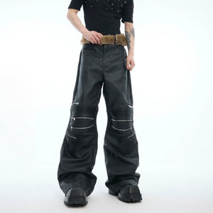 Deconstructed high-waist leather pants with metal zipper detailing, showcasing streetwear punk style