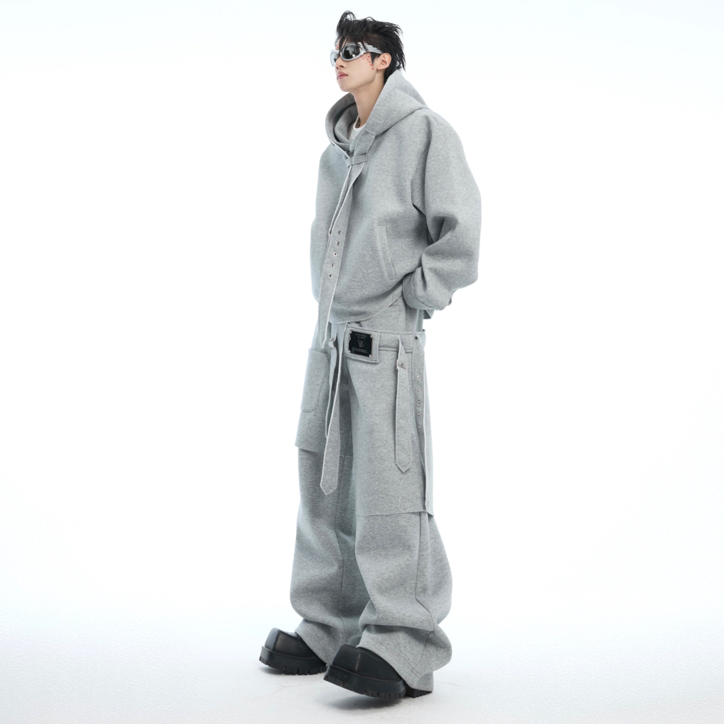 Side angle showing the unique detachable sash feature of this oversized streetwear hoodie set with metal print