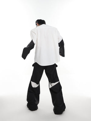 Model wearing the oversized liquid metal shoulder shirt showing its relaxed fit and dimensional metallic effect