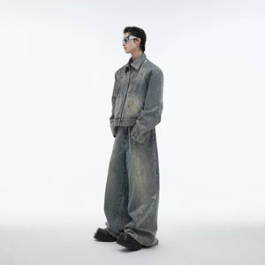 Distressed denim jacket with laser-cut details and raw edges, featuring asymmetrical punk rock styling