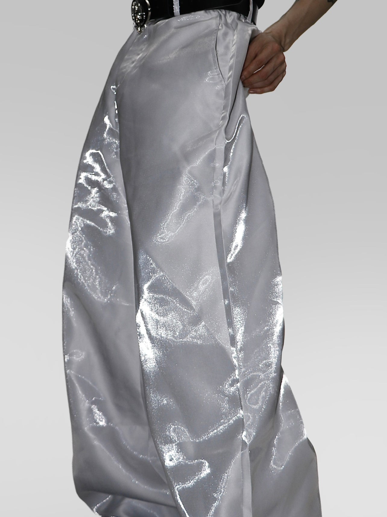 Front view of liquid-shine drop-crotch dress pants showing unique 3D advanced cutting and architectural silhouette