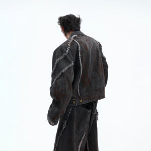 Detail shot of 3D cut pockets on loose fit distressed denim jacket with punk aesthetic