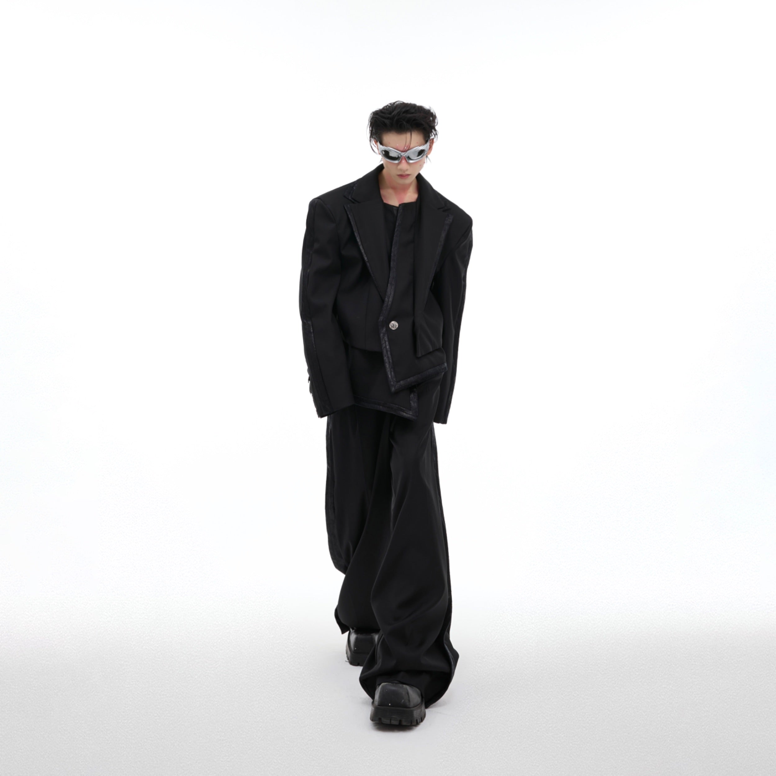 Oversized deconstructed suit with wide-leg pants showing the full streetwear ensemble for fashion-forward individuals
