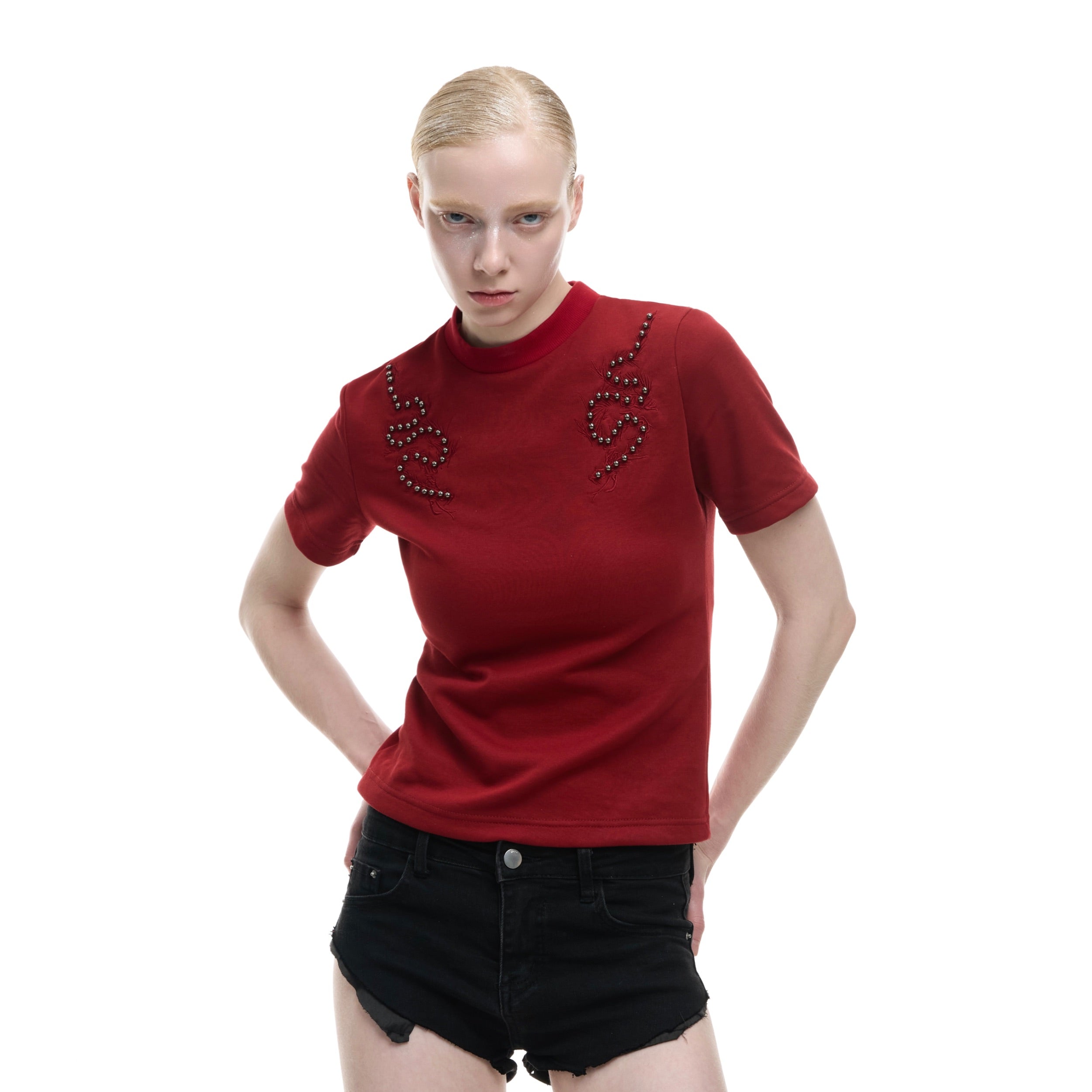 Back view of urban streetwear tee featuring metal rivet accents and premium embroidery craftsmanship