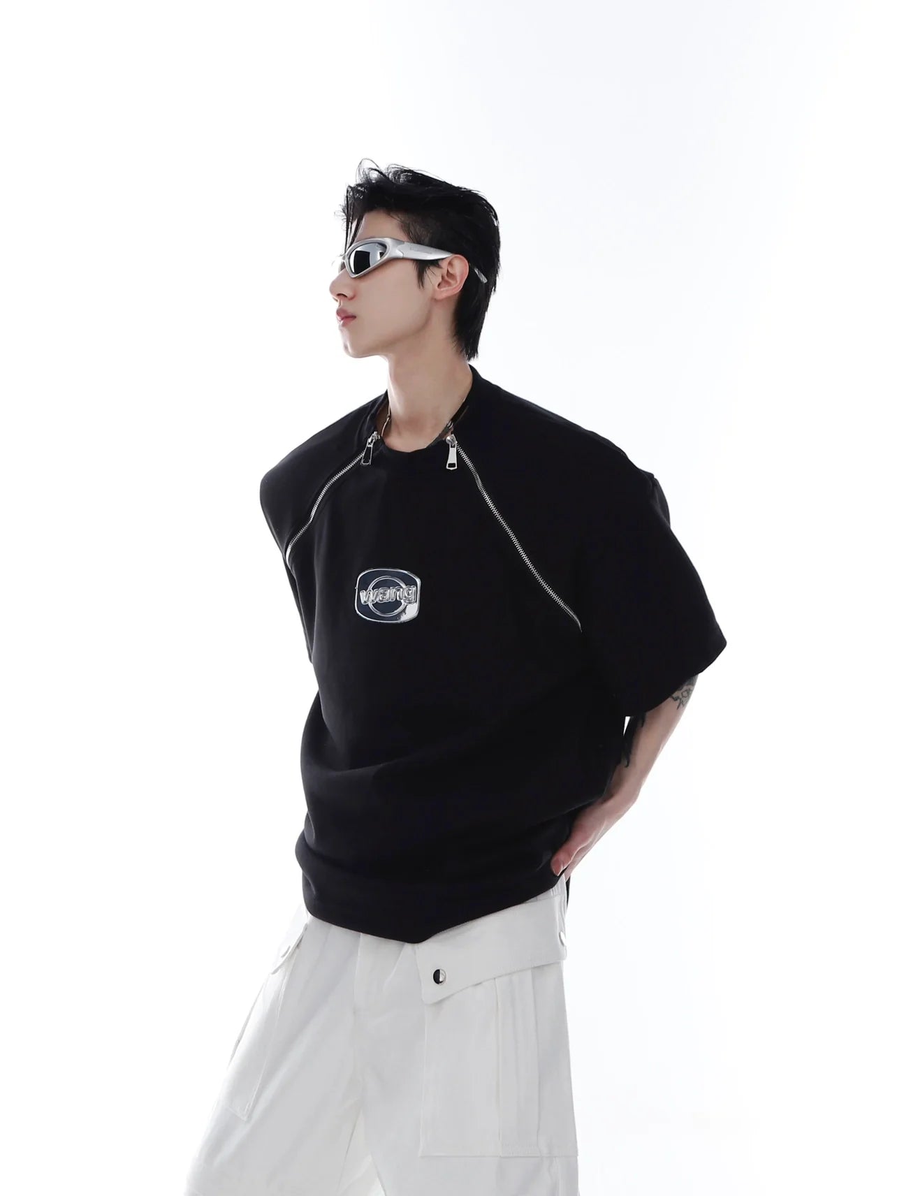 Front view of avant-garde white zip-up tee with metal trim detailing and structured shoulder pads for streetwear looks