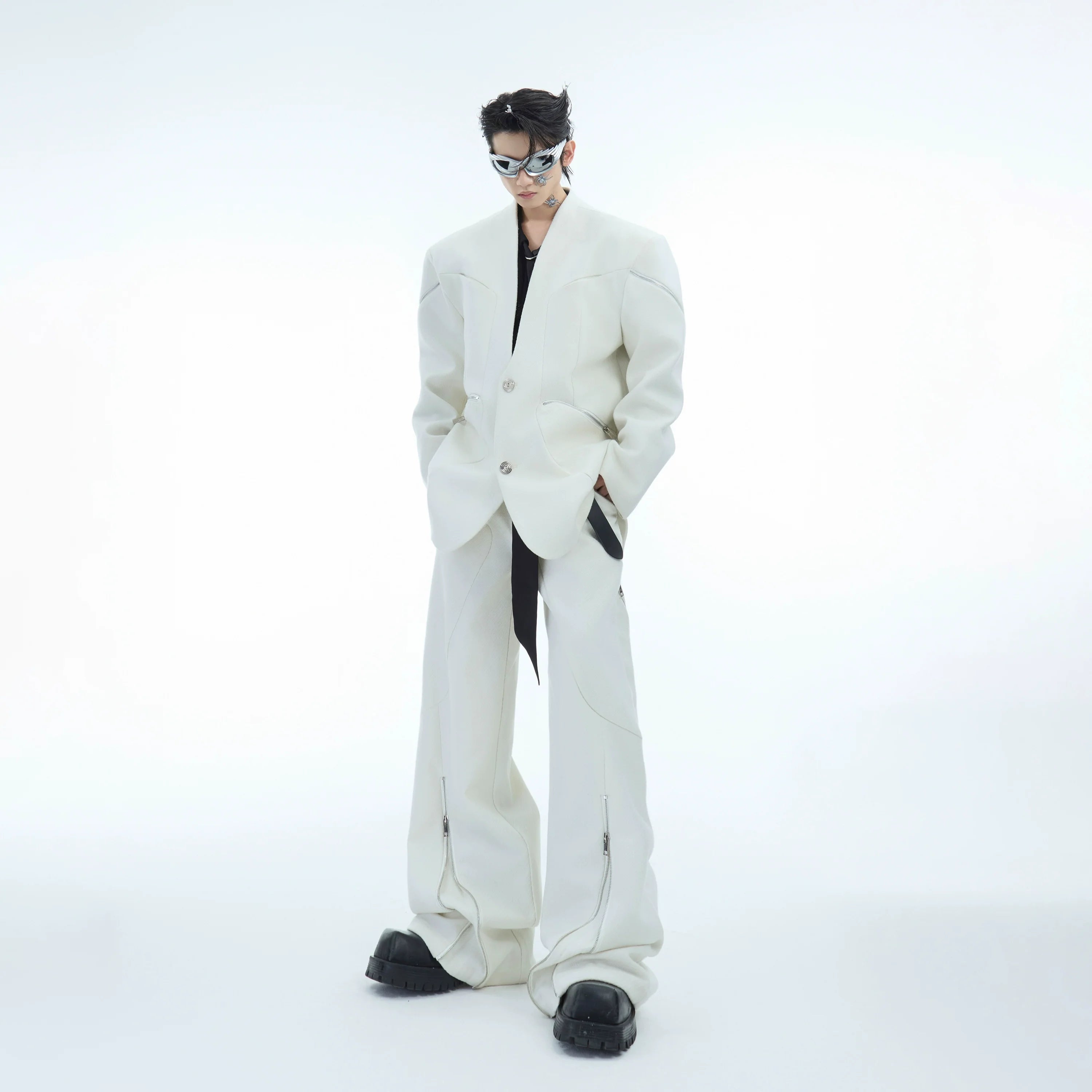 Front view of deconstructed blazer with metal zippers showing twill texture and low-cut neckline design