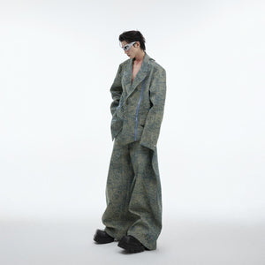 Side angle showing the statement metal zipper and asymmetrical cut of this edgy denim blazer