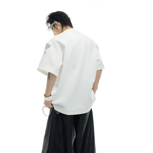 Detail shot of edgy metallic neckline hardware on distressed gold sequin t-shirt