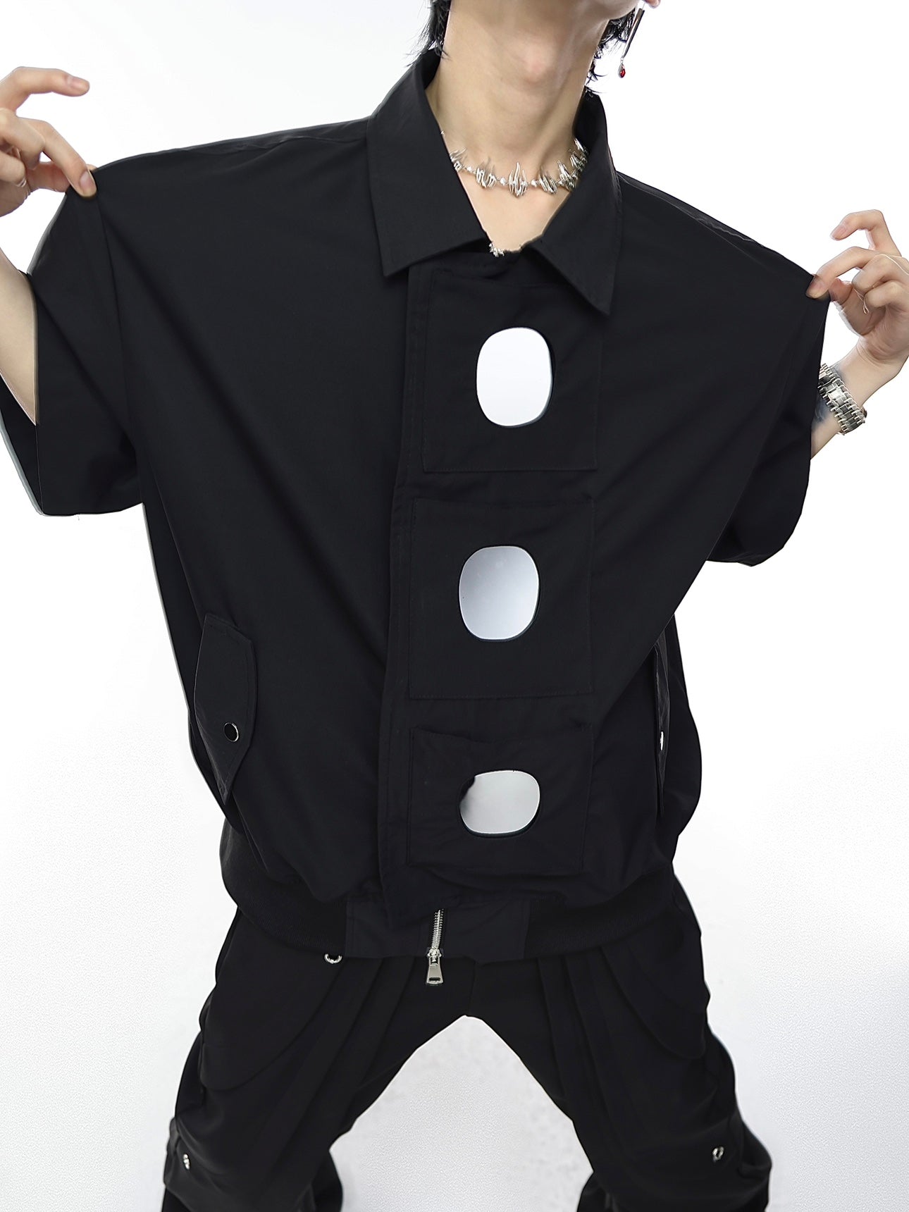 Front view of oversized streetwear jacket showing three functional pockets with acrylic mirrors