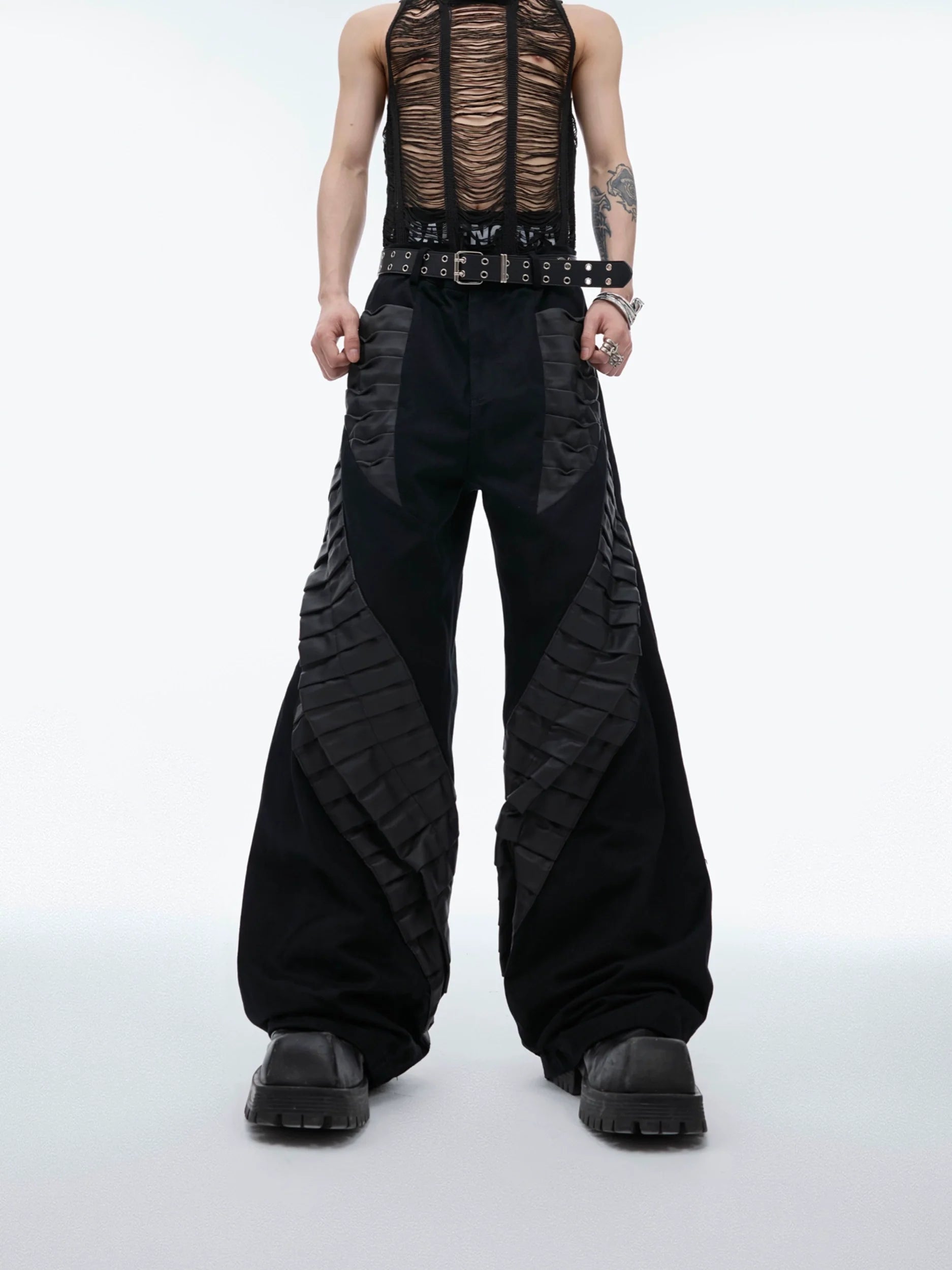 Front view of oversized cargo pants featuring avant-garde 3D pleats and drop-crotch design for streetwear fashion
