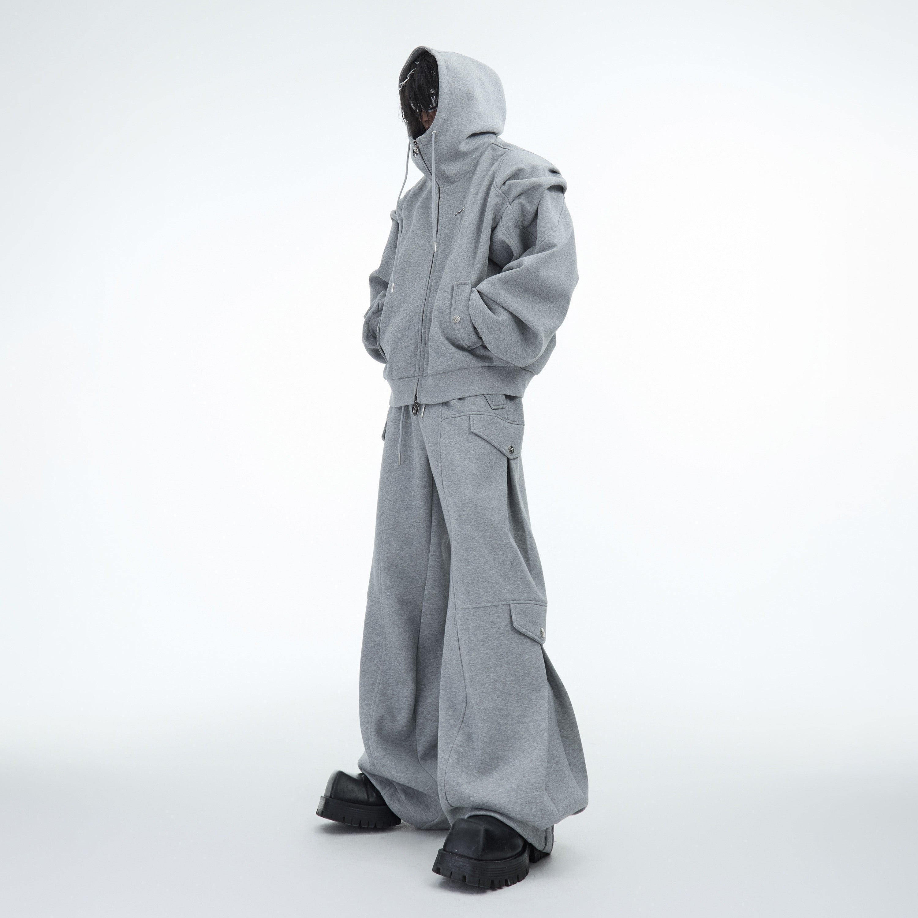 Front view of oversized hoodie with drop shoulder and pleat design, showcasing urban streetwear style