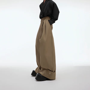 Front view of oversized metal-stud trousers with futuristic 3D deconstructed design for avant-garde streetwear