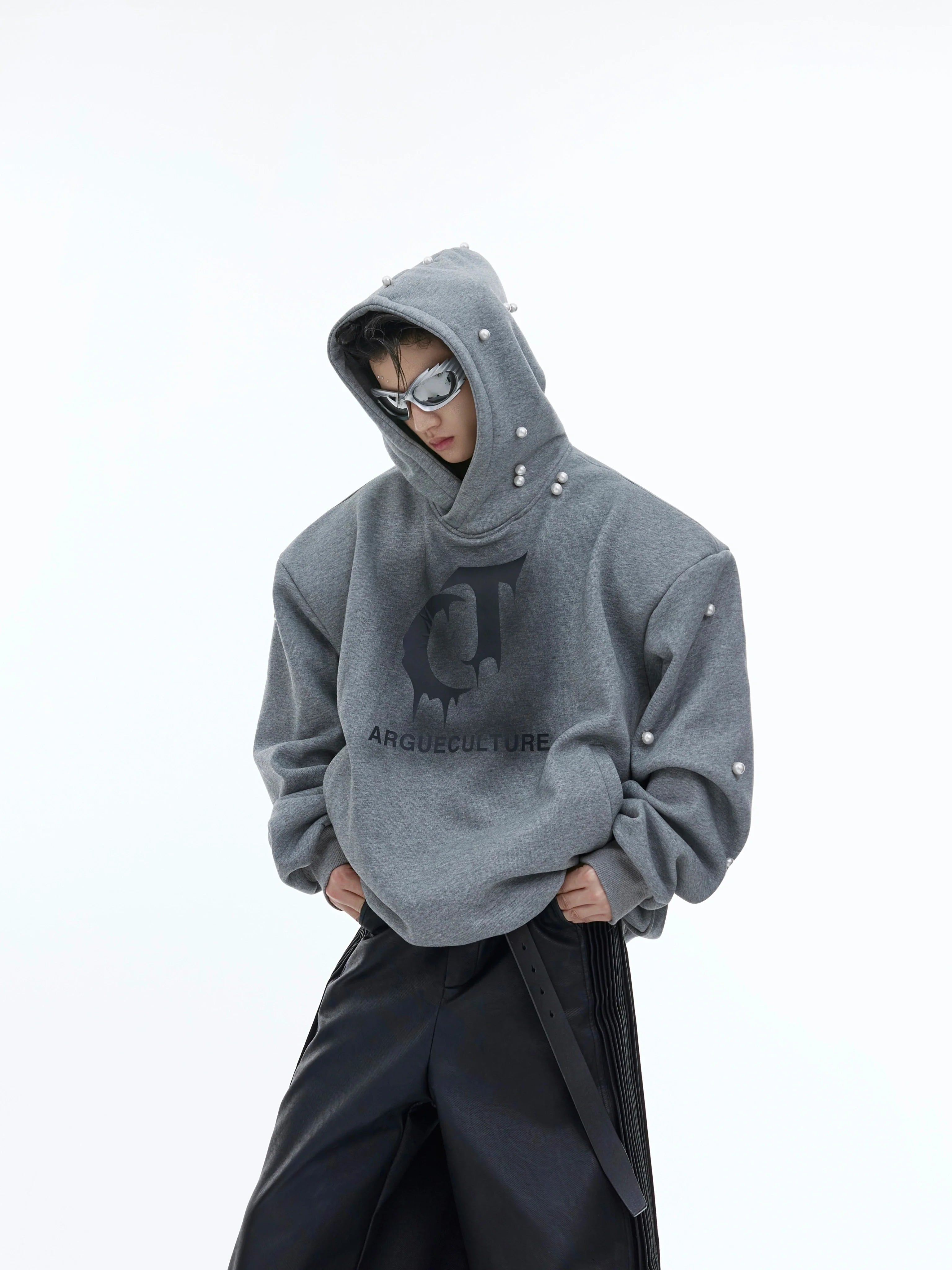 Front view of oversized pearl-accented hoodie with fleece lining, featuring bold streetwear graphic print