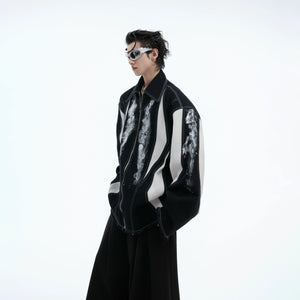 Deconstructed oversized shirt-jacket featuring bold color-block design and statement shoulder pads for edgy streetwear look
