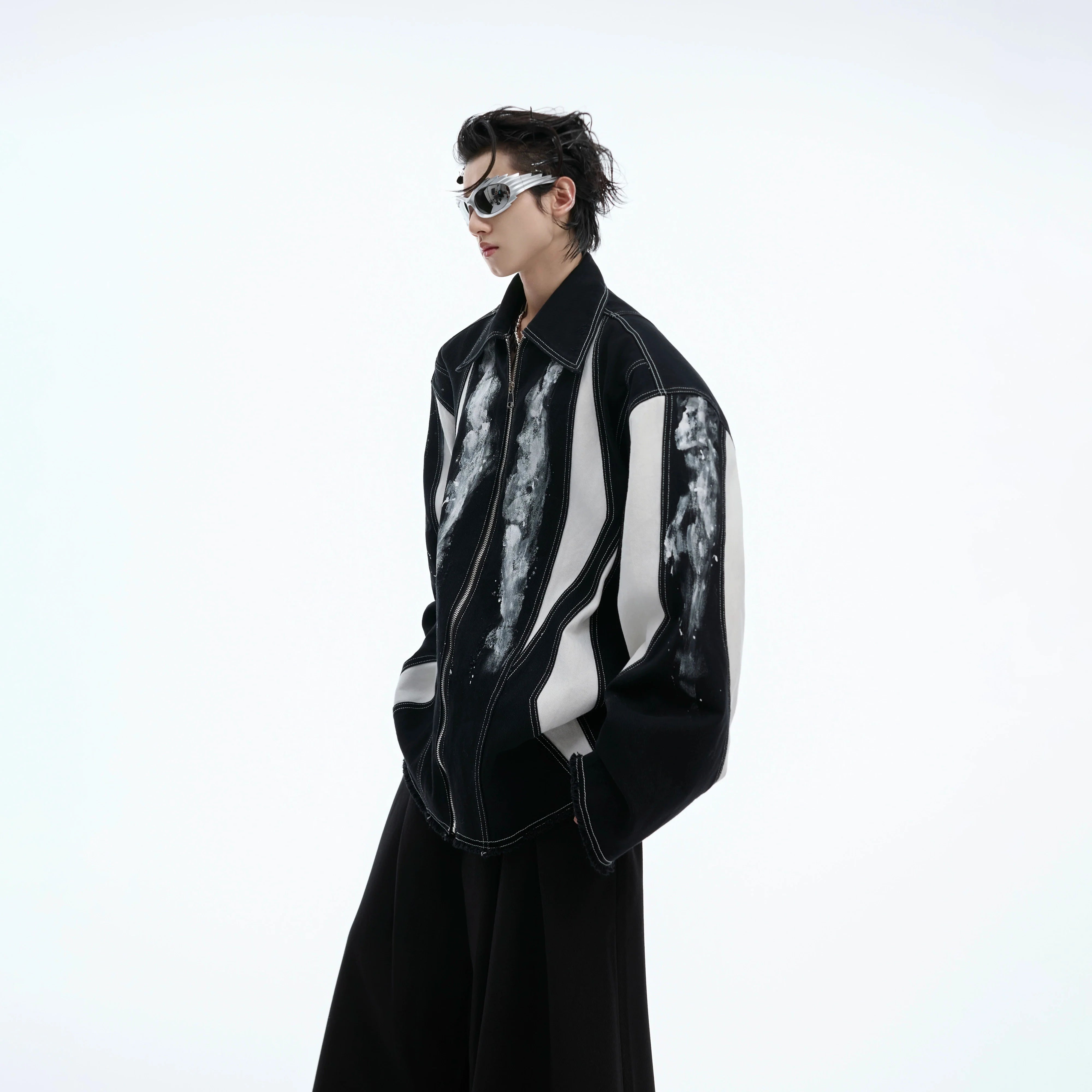 Deconstructed oversized shirt-jacket featuring bold color-block design and statement shoulder pads for edgy streetwear look