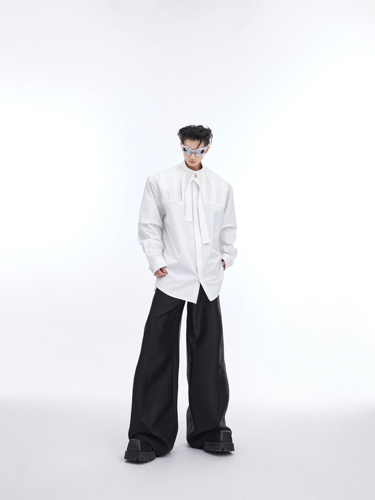 Front view of deconstructed loose shirt showing avant-garde patchwork design and asymmetrical hem