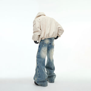 Back view of distressed two-way puffer jacket featuring oversized hood and urban streetwear design