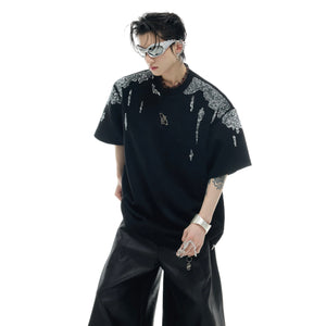 Front view showing bold logo placement on distressed gold sequin oversized t-shirt