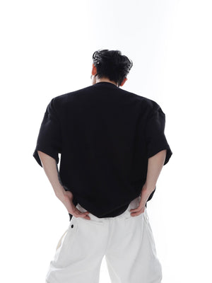 Detailed shot of the striking metallic 3D chest print on this edgy minimalist streetwear top