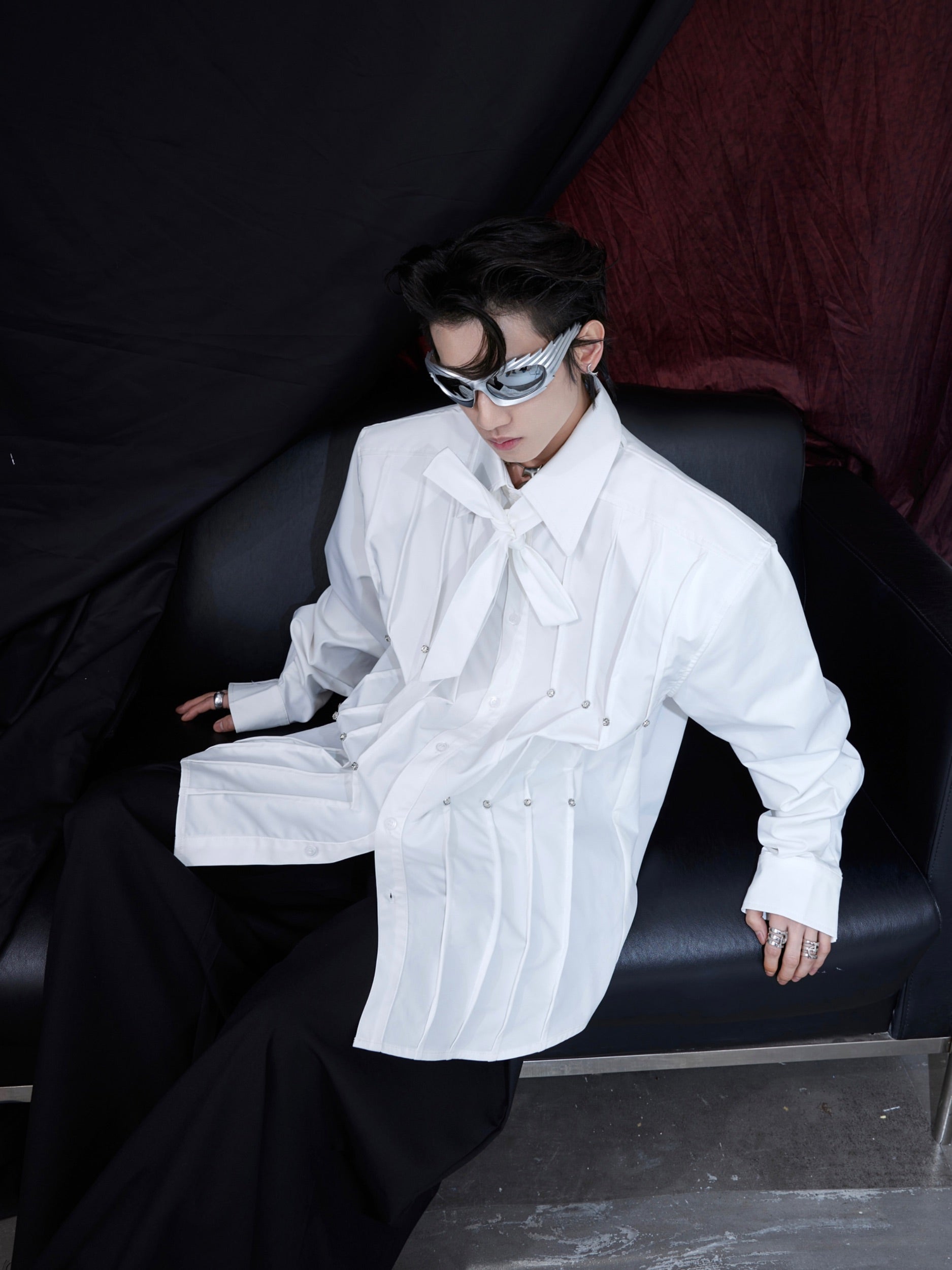 Front view of oversized white shirt with 3D pleats and shoulder pads, streetwear fashion for men and women