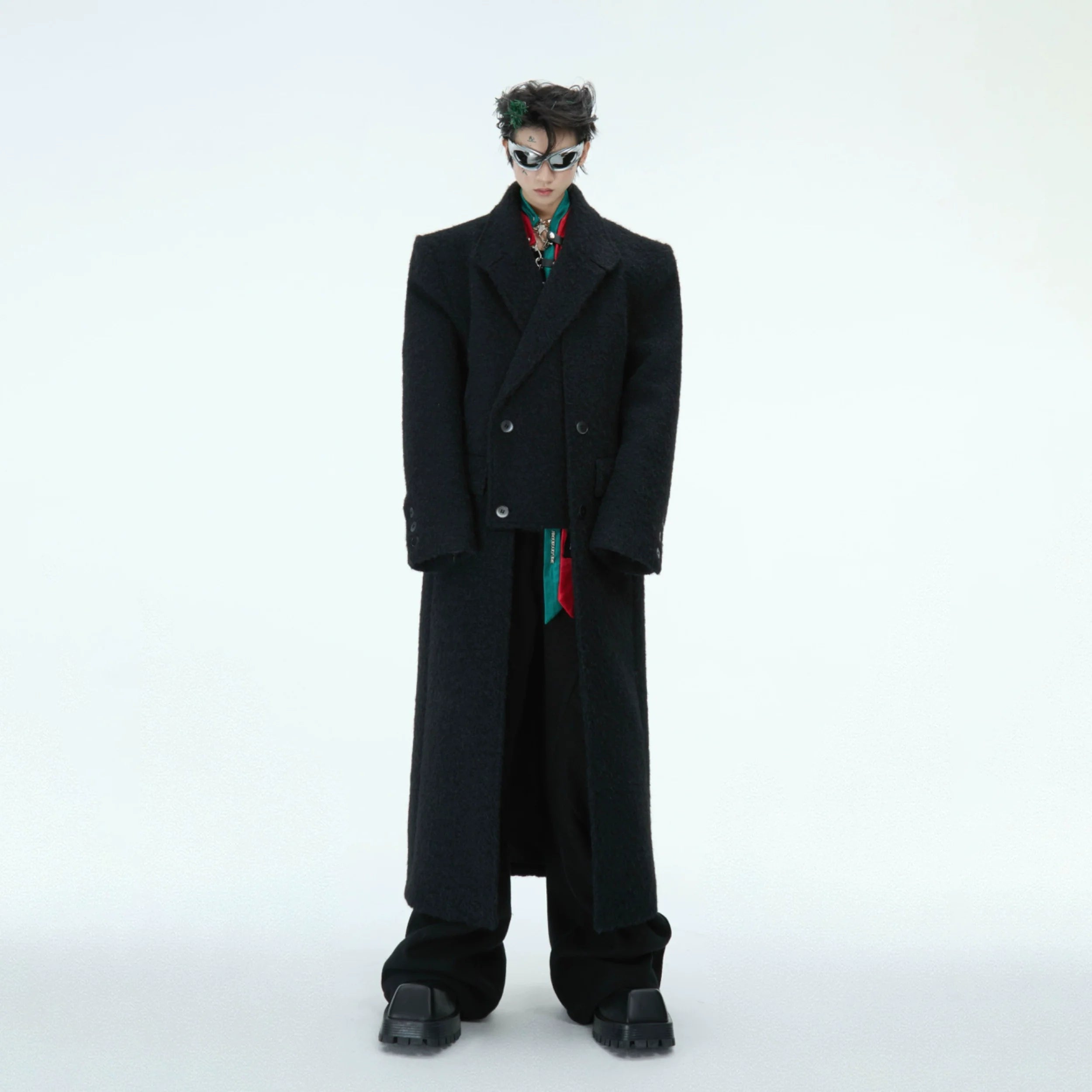 Front view of oversized deconstructed wool coat with dramatic split hem, showcasing the streetwear-inspired design