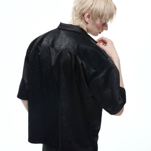 Signature folded collar detail on turquoise patchwork streetwear shirt showing premium construction