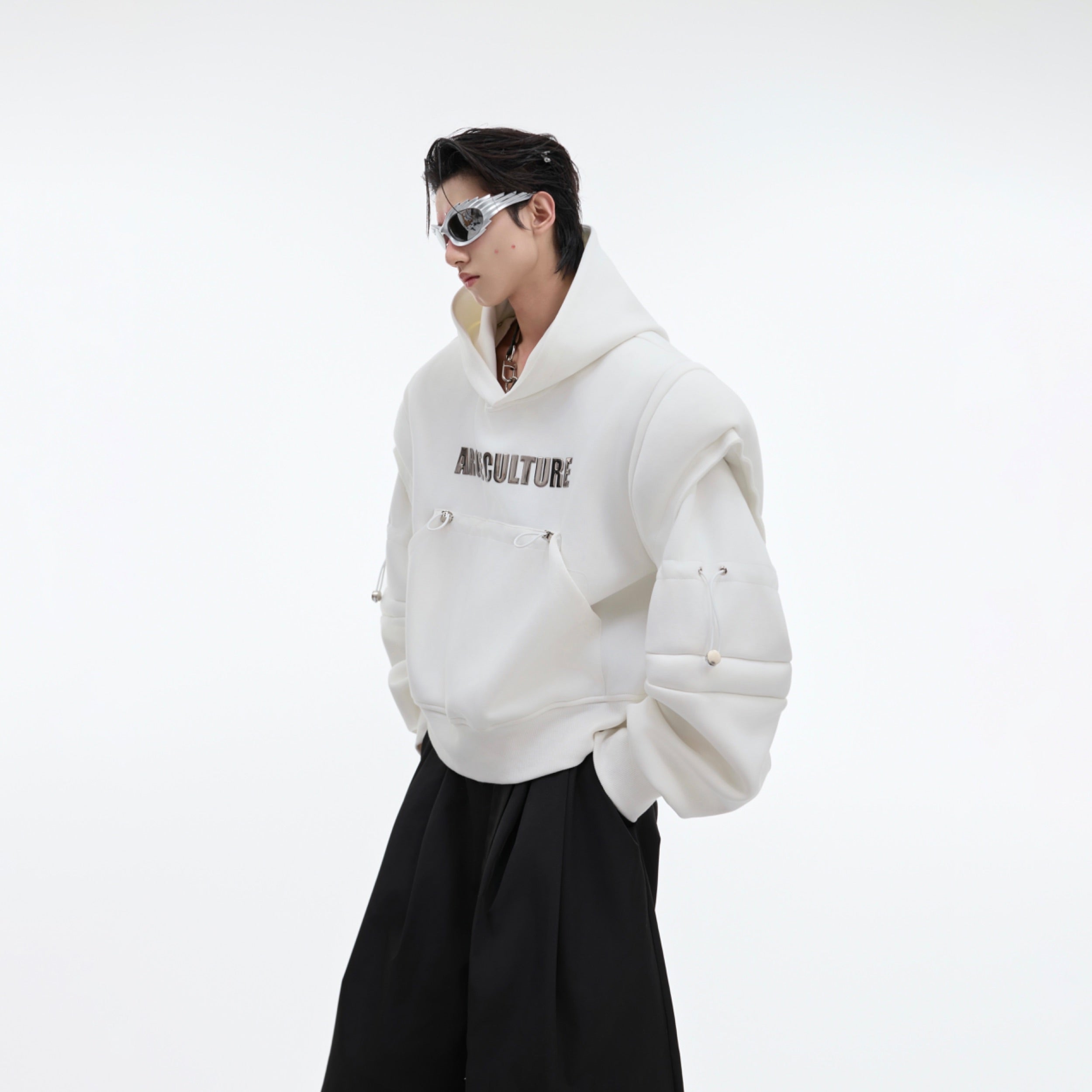 Close-up view of unique patchwork detailing on this cropped oversized hoodie with deconstructed elements