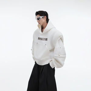 Close-up view of unique patchwork detailing on this cropped oversized hoodie with deconstructed elements